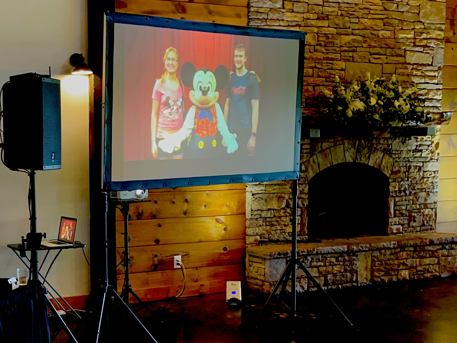 Slideshow screen set up beside the fireplace at the reception