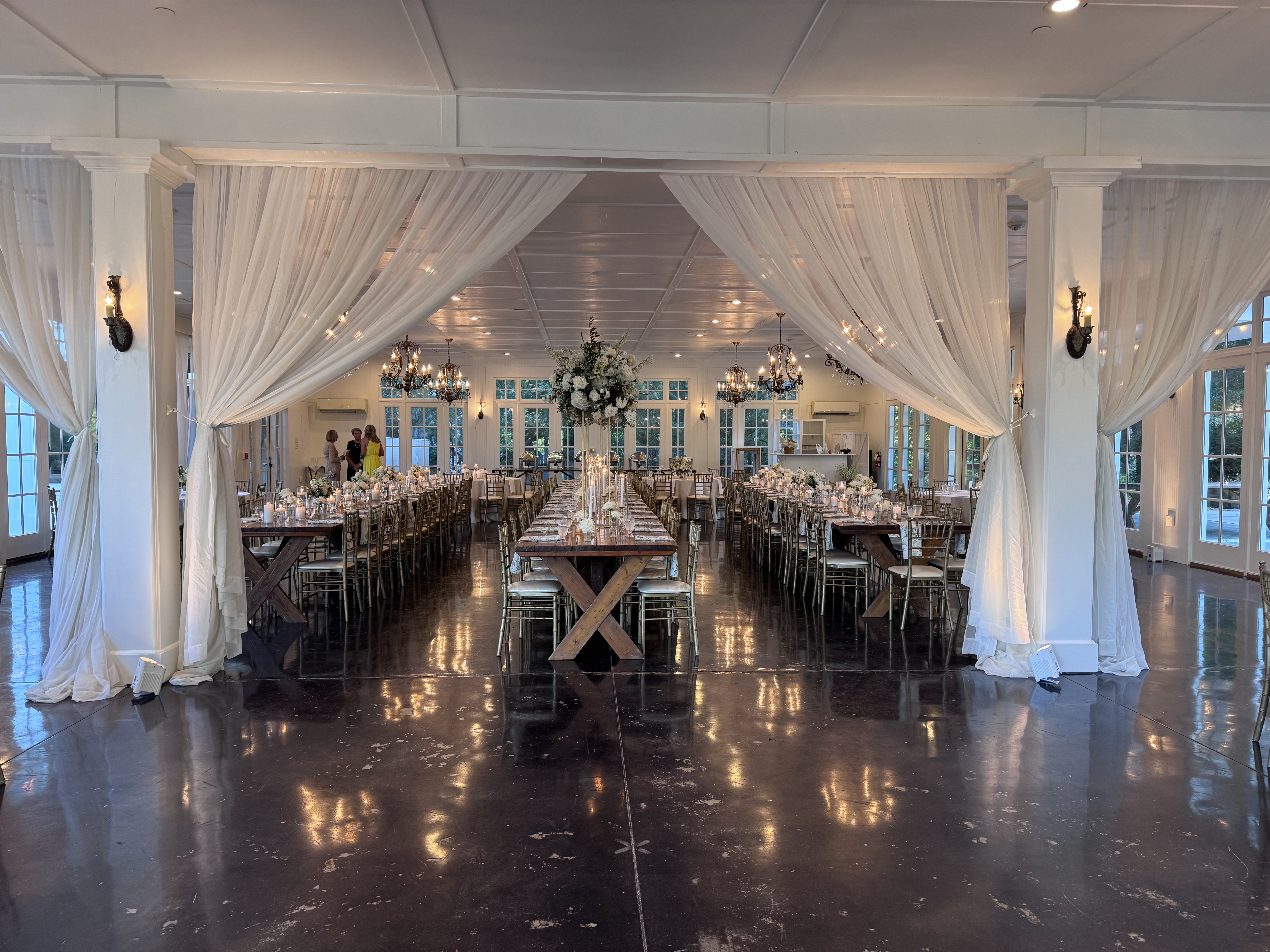 Uplighting washing white drapes at Little River Farms